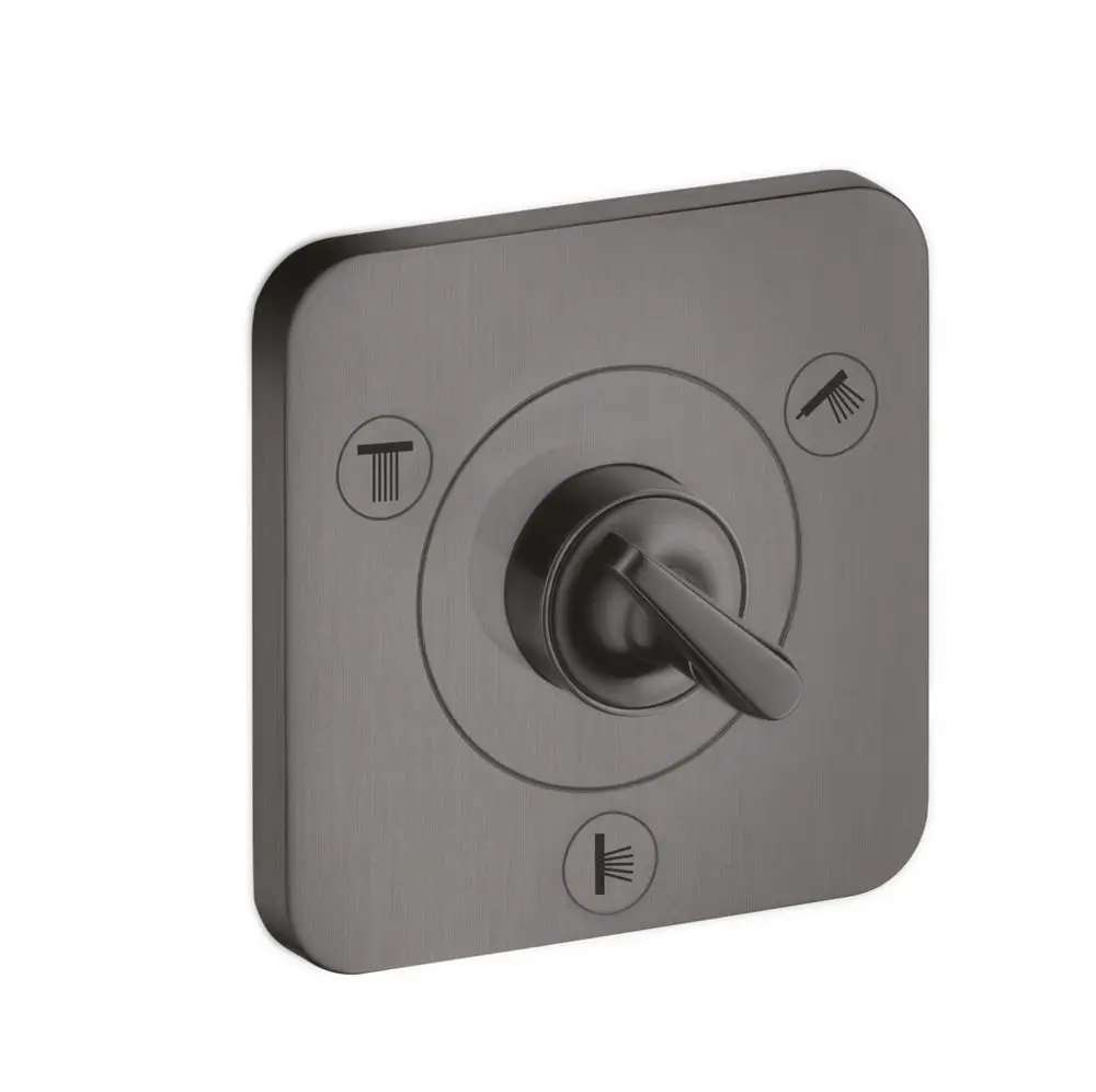 AXOR Ventil in Brushed Black Chrome mit einem zentralen Drehkopf und Symbolen zur Auswahl zwischen verschiedenen Ausgängen. Montage erfolgt unter der Wandoberfläche.